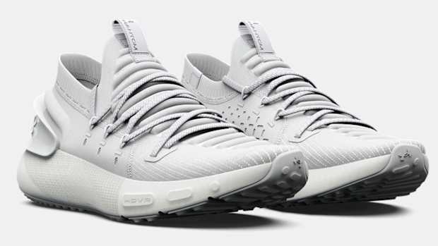 Side view of grey Under Armour running shoes.